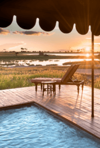 View of the waterways from the pool deck at Jacks Camp when you book a package stay between Jacks, Tuludi and Tawana. Book with Think Africa Travel