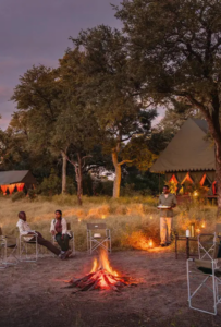 Mbamba in the heart of the wild - sunset around an open fire just before dinner is served.- quiet-peaceful-undisturbed
